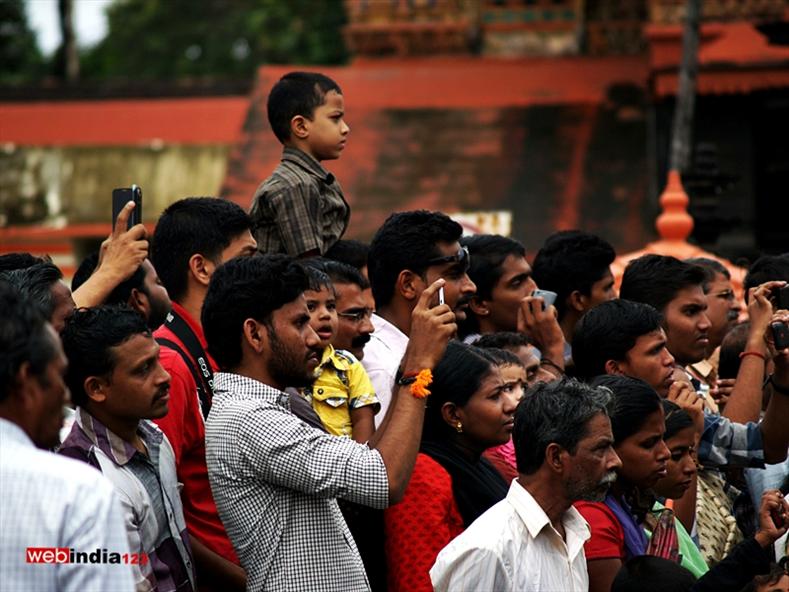 People taking photos during Tripunithura Athachamayam