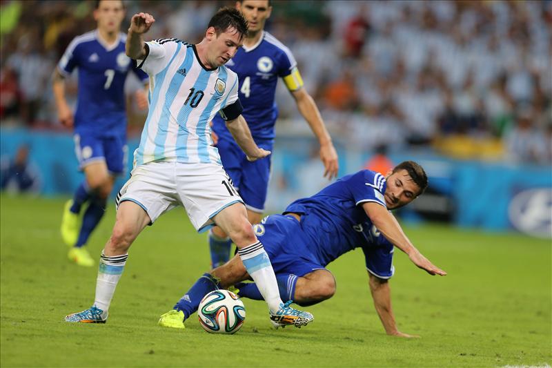 Argentina's Lionel Messi vies for the ball during a match between Argentina and Bosnia- Herzegovina of 2014 FIFA World Cup