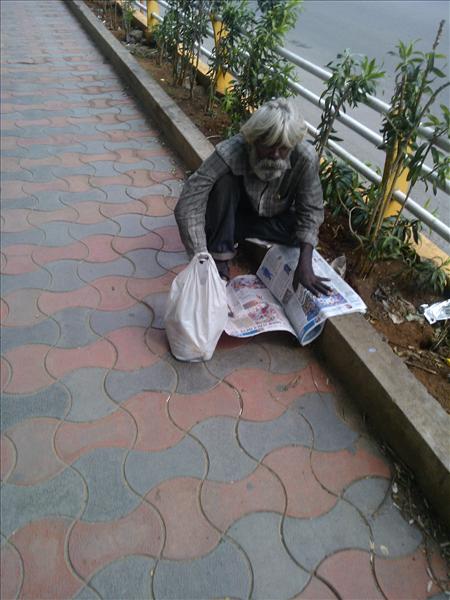 beggar with newspaper