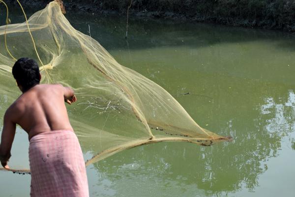 a fisherman is just ready with fish net