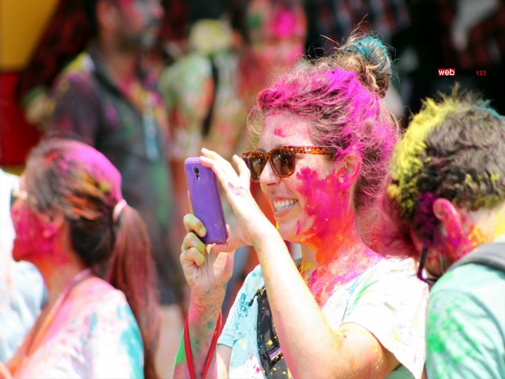 A Foreign taking photos during Holi at Mattancherry